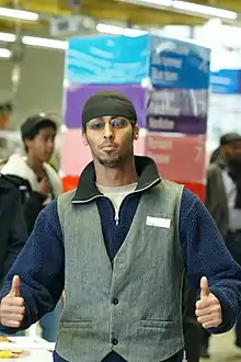 Image 143Somali man wearing waistcoat, tuque and polar fleece (from 2010s in fashion)