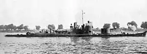 a black and white photograph of a ship on a river