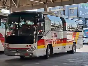 A JAM Liner bus wearing red-yellow livery after took over by JAC Liner.