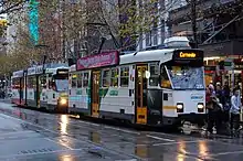 A pair of southbound Melbourne trams embark passengers in Swanston Street just north of Little Collins Street, May 2012