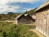 Several large decoratively carved houses with peaked roofs made entirely of fitted wooden planks