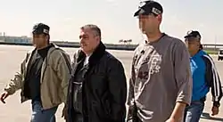 Zeev Rosenstein, escorted by federal agents, on his way from Israel to trial in the U.S.