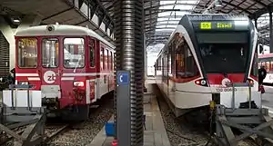 zb trains at Lucerne, Stadler Spatz at right.