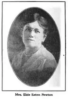 A white woman's head and shoulders portrait, in an oval frame. She is wearing glasses and a light-colored blouse; her dark hair is parted and dressed back.