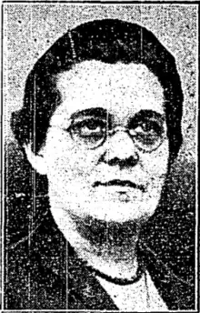 three quarter pose portrait of Florence Custance wearing glasses