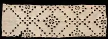 fragment of old fabric 14 x 45.4 cm (5 1/2 x 17 7/8 in.) with a diagonal pattern of fabric cut away