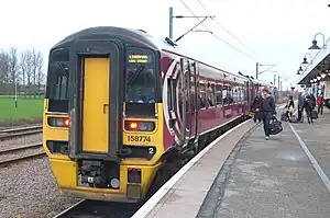 A flat-fronted, purple Class 158 train with two carriages: "Liverpool Lime Street"