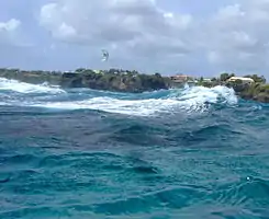 The free divers surfaced outside the inner reef to see this kite surfer in fairly severe conditions.