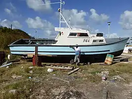 Patrick the proud owner saw the camera and asked the photographer to take a picture of him with his boat at Conset Bay.