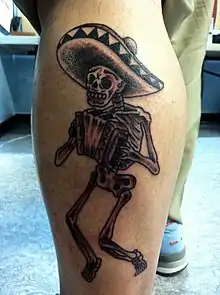 A tattoo of a skeleton with sombrero and accordion