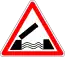 A triangle with white background and red border, with a symbol of an open draw bridge