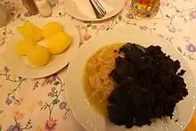 Baked blood with sauerkraut and potatoes