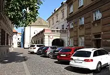 An old European street with parked cars