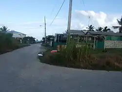 Turn right from the bus route past this Rum Shop.