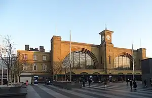 London King's Cross station with huge grand arches and a clock on top