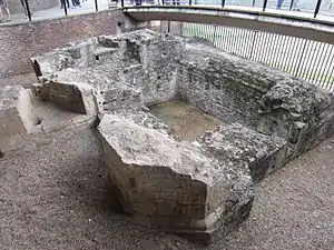 Photograph of excavated ruins in a sunken area.