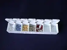 A pill organizing box with seven compartments