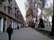 People walking down a very wide pavement on Rudake Avenue in Dushanbe