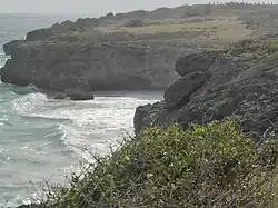 The beach lies enclosed in these unforgiving cliffs. Targets of the Barbados Defence Force line the skyline.