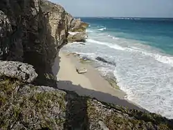 From above the beach reveals some unwelcoming rocks and the photographer could not spot an obvious way up or down.