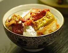 A bowl of rice topped with cubs of fake meat